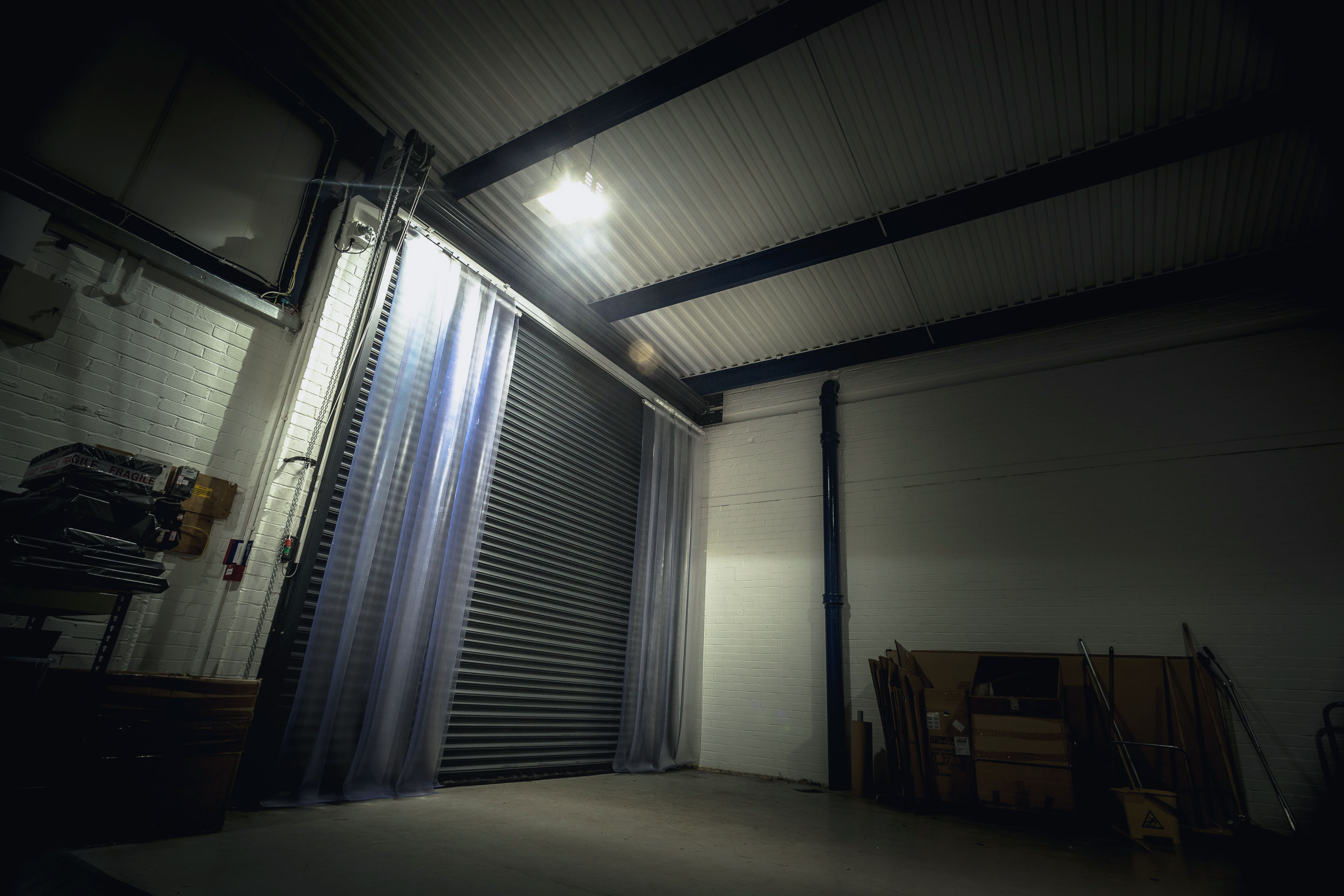 Interior view of factory door with clear plastic pvc strip curtain